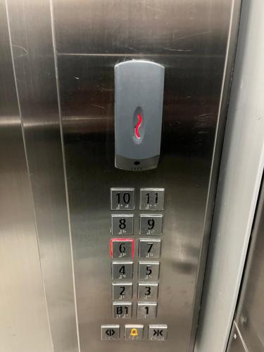 a close up of an elevator with a red button at Manukau Studio Apartments in Auckland