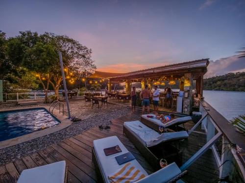 a group of people standing on a dock next to the water at Edgewater Dive & Spa Resort in Puerto Galera