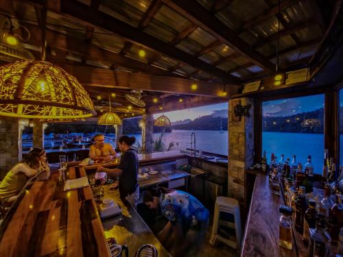 a bar with a view of the water at Edgewater Dive & Spa Resort in Puerto Galera