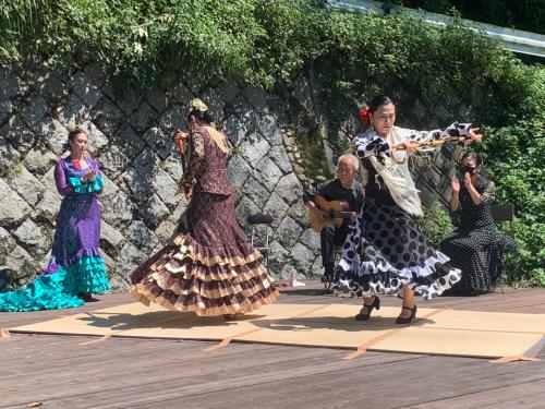 a group of people dancing on a wooden deck at Kizuna Guesthouse in Kizugawa