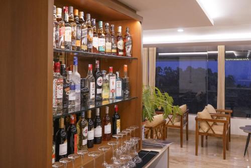 a bunch of bottles of alcohol on a wall at Tea Tree Suites,Manipal in Manipala