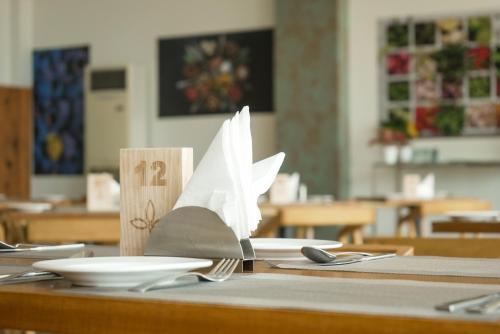a table with a paper boat on top of it at Tea Tree Suites,Manipal in Manipala