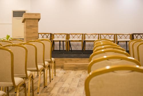 a row of chairs lined up in a room at Tea Tree Suites,Manipal in Manipala