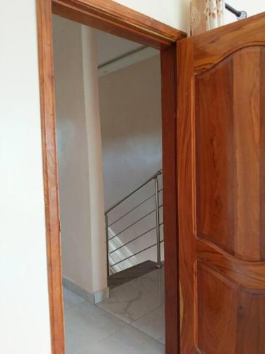 a room with a staircase and a wooden cabinet at Porto-Novo Charme Townhouse in Porto-Novo