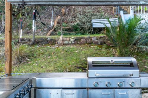 a stove top oven sitting in a garden at The Boathouse in Daleys Point