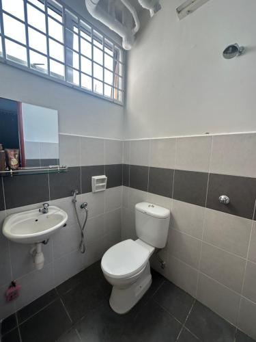 a bathroom with a toilet and a sink at The Myrini Homes - Cityview Near Drawbridge in Kuala Terengganu