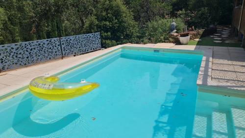 a toy boat sitting in a swimming pool at Mon petit Eden in Le Muy