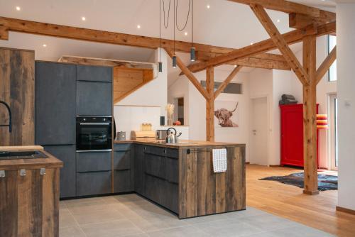 a kitchen with wooden cabinets and a kitchen island at 12er Huus in Bürserberg