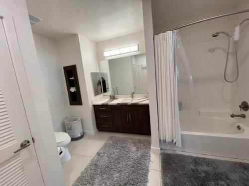 a bathroom with a shower and a toilet and a sink at Luxurious Apartment Bardeen New Port Beach 1 Bedroom in Irvine