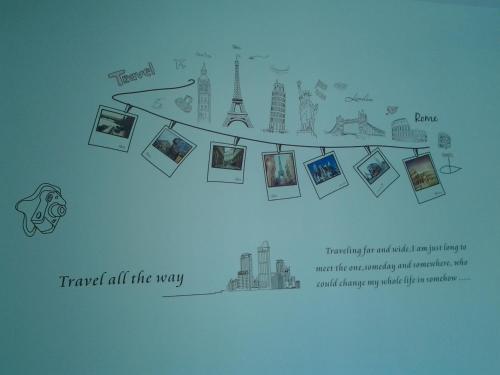 a map of the world with pictures of monuments at Makerhouse Hostel in Hefei