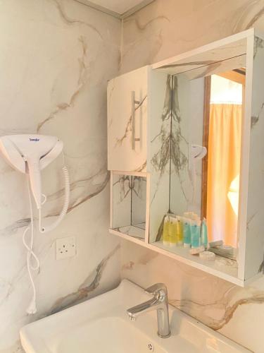a bathroom with a sink and a mirror at Tamim Luxury wadi rum camp in Wadi Rum
