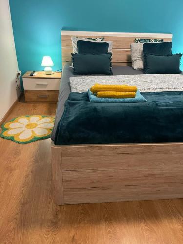 a bedroom with a large bed with a blue wall at Veľký apartman in Karlova Ves