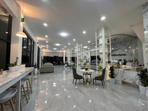 a lobby with chairs and tables in a store at DMhotel&cafe in Nan