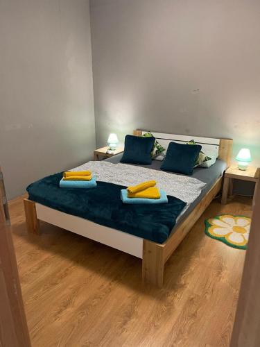 a bedroom with a bed with blue and yellow pillows at Veľký apartman in Karlova Ves
