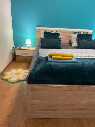 a bedroom with a large bed with a blue wall at Veľký apartman in Karlova Ves