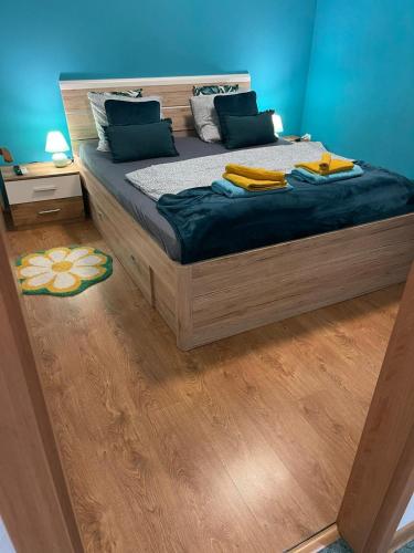 a bedroom with a large bed with blue walls at Veľký apartman in Karlova Ves