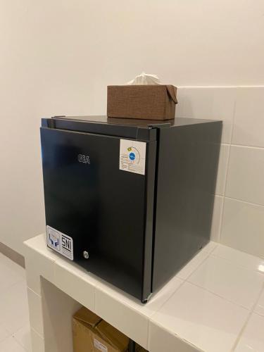 a black refrigerator sitting on top of a counter at Tokyo riverside ocean view in Tangerang