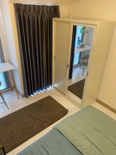 1 dormitorio con espejo, cama y mesa en Tokyo riverside ocean view en Tangerang