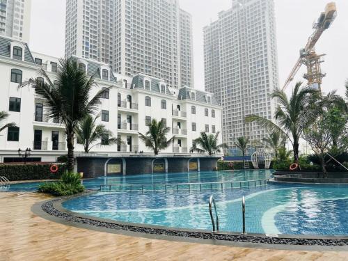 a large swimming pool in a city with tall buildings at Homestay Smart - Vinhomes Tu Liem Ha Noi in Hanoi