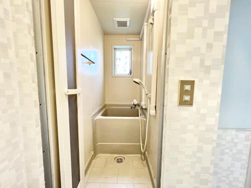 a bathroom with a shower and a bath tub at Tranquil house with 3 bedrooms 7min to metro straight to Shinjuku and Shibuya in Tokyo