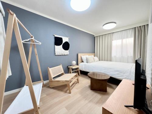 a bedroom with a bed and a tv in a room at Tranquil house with 3 bedrooms 7min to metro straight to Shinjuku and Shibuya in Tokyo