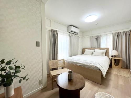 a small bedroom with a bed and a table at Tranquil house with 3 bedrooms 7min to metro straight to Shinjuku and Shibuya in Tokyo
