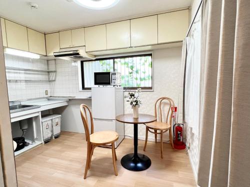 a kitchen with a table and chairs in a room at Tranquil house with 3 bedrooms 7min to metro straight to Shinjuku and Shibuya in Tokyo