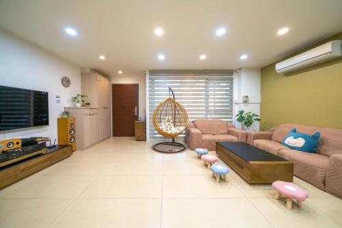 a living room with a couch and a tv at Luodong warm house in Luodong