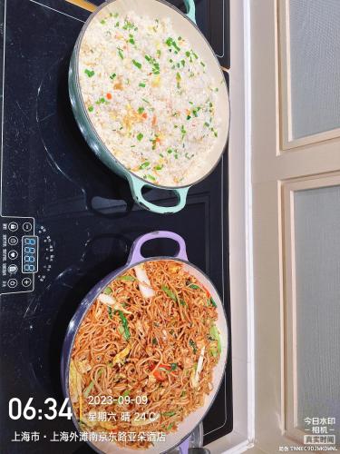 two pans of food are in an oven at Shanghai Atour Hotel On The Bund- People Square in Shanghai