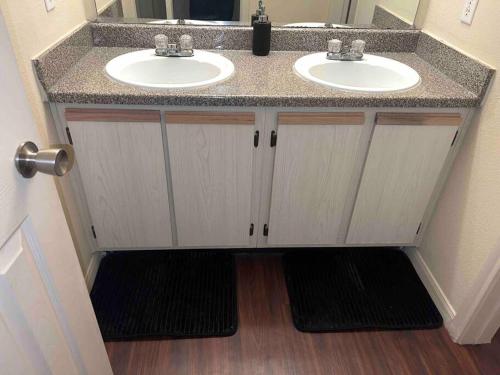 a bathroom with a sink and two sinks at Everything you need to call home in Norman