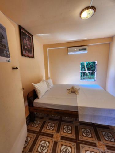 a small room with a bed and a window at Sweet View Guesthouse in Koh Rong