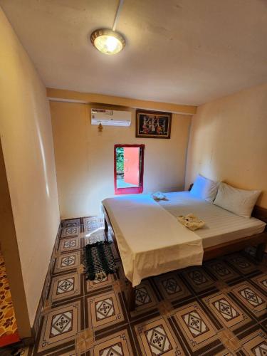a bedroom with a large bed and a window at Sweet View Guesthouse in Koh Rong