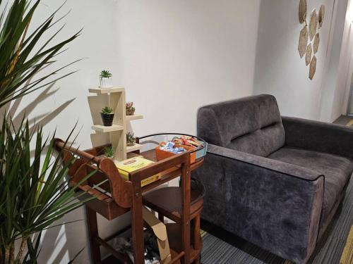 a living room with a couch and a table and a chair at le melur guest house in George Town