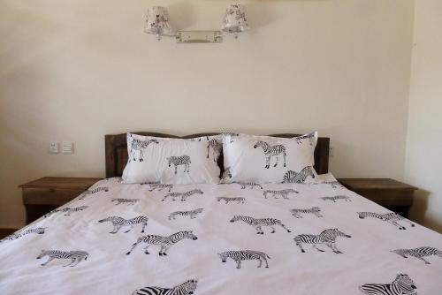 a bedroom with a bed with zebra prints on it at Tourist Courtyard Hotel in Jianchuan