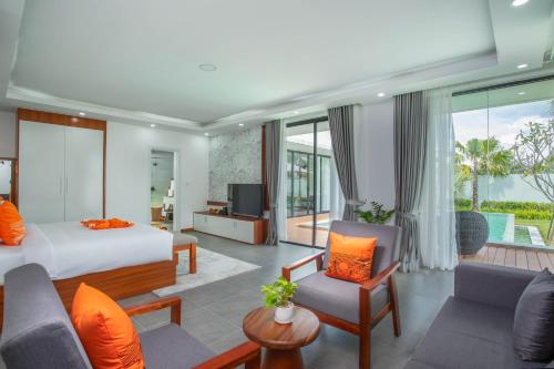 a bedroom with a bed and a living room at Wonderland Suites and Resort in Sihanoukville