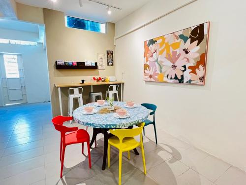 a dining room with a table and colorful chairs at myROOM @ Mandalay Georgetown, Off Jln Burma, Gurney Drive in George Town