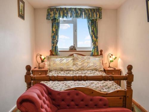 a bedroom with a wooden bed and a window at Shiralee bed and breakfast in Salisbury