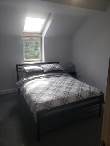 a bedroom with a bed with a window in it at Whispering heights in Manchester