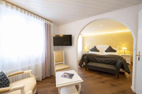a bedroom with a bed and a large mirror at Seilers Vintage Hotel & Spa in Kandersteg
