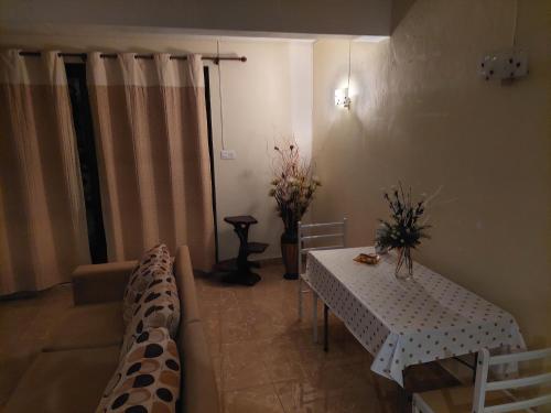 a living room with a table and a couch at Cozy Studio at Pointe aux Canonniers in Pointe aux Cannoniers