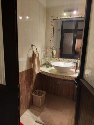 a bathroom with a sink and a mirror at Cozy Studio at Pointe aux Canonniers in Pointe aux Cannoniers