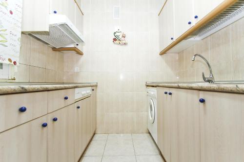 a kitchen with a sink and a dishwasher at Mar Pineda Planet Costa Dorada in La Pineda