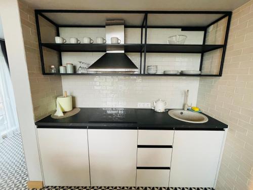 a kitchen with a counter and a sink at Duarto house, Sauna and Hot Tub in Šiaudinė