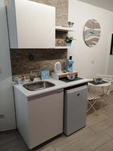 a kitchen with a sink and a counter top at La casa dei nonni in Bari