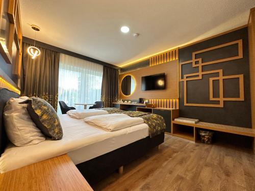 Кровать или кровати в номере Hotel Belen Fahrenkrug