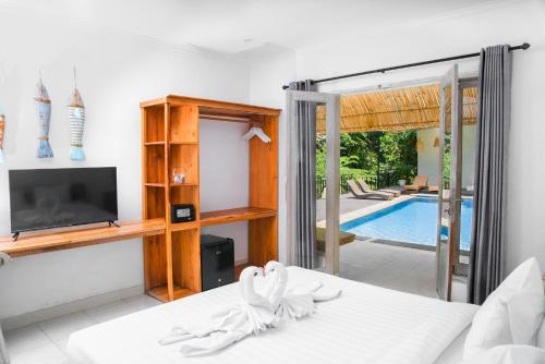 a bedroom with a bed and a tv and a pool at Bali Invest Living in Canggu