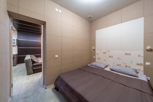 a bedroom with a large bed in a room at Просторная стильная студия возле метро Южный Вокзал. in Kharkiv