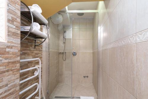 a shower with a glass door in a bathroom at Heritage Hotel Pasike in Trogir