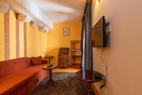 a living room with a couch and a table at Heritage Hotel Pasike in Trogir