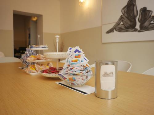 a candle sitting on a table with snacks on it at La Boheme SMART Hotel in Turin